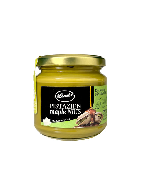 Lemke Pistazien Maple Mus 180g jar with pistachio spread and maple sugar on white background